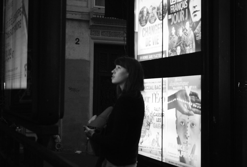 woman in black long sleeve shirt standing near wall