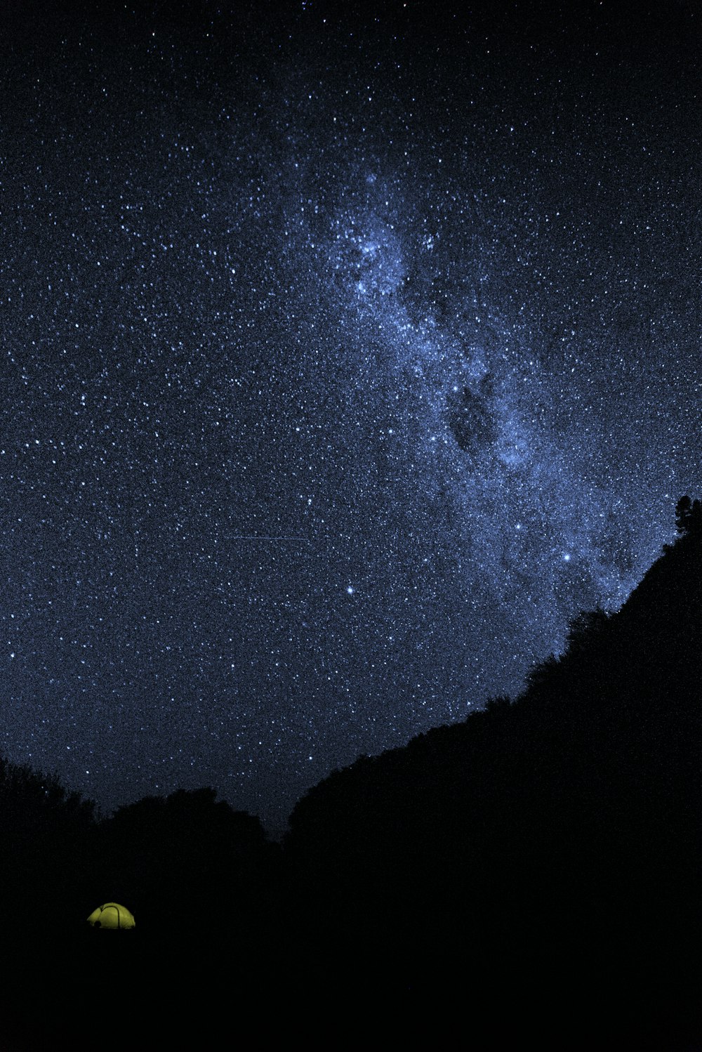 silhouette of mountain under starry night