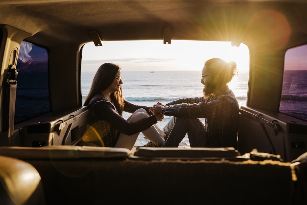 man and woman sitting on boat during daytime