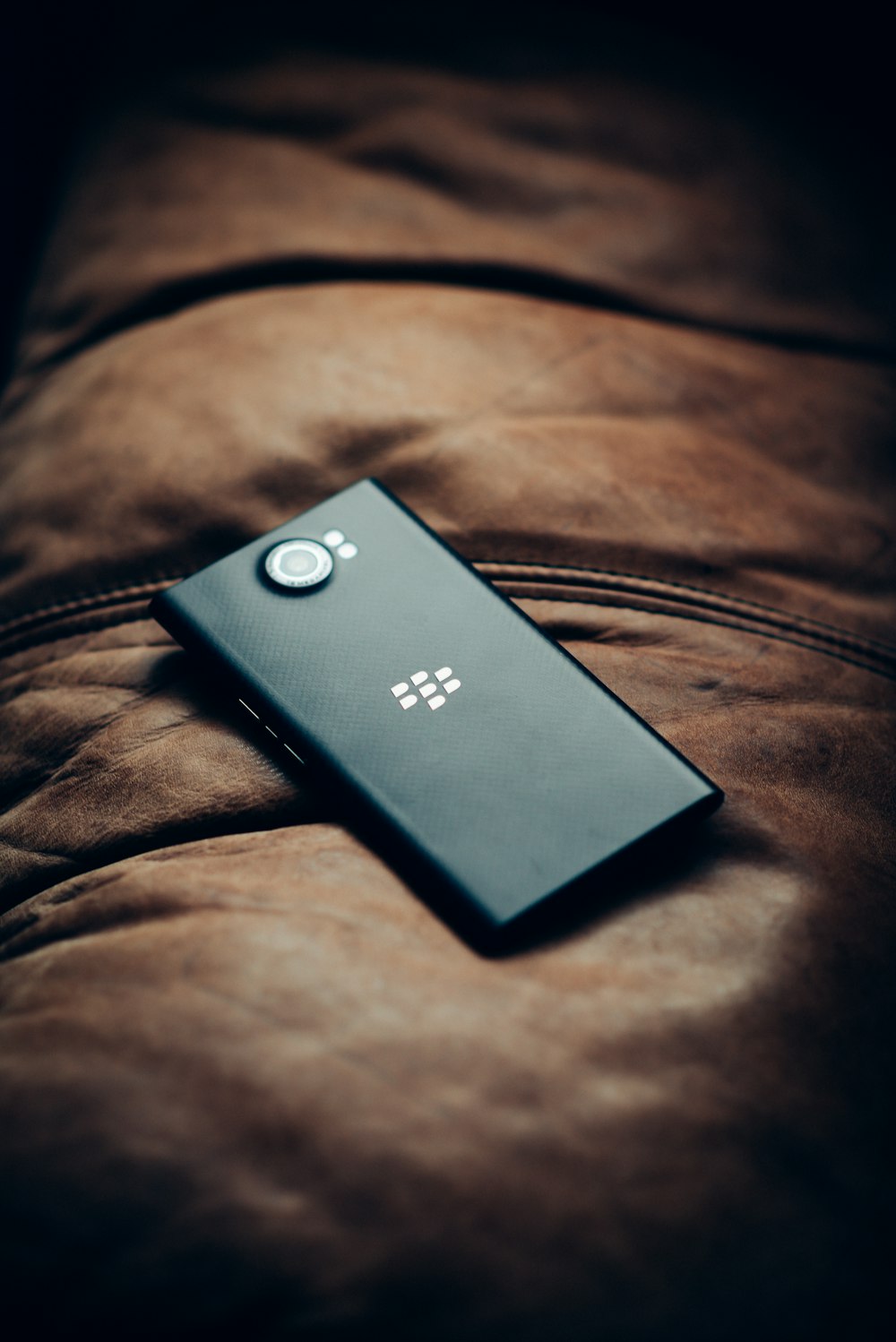 black lg smartphone on brown textile