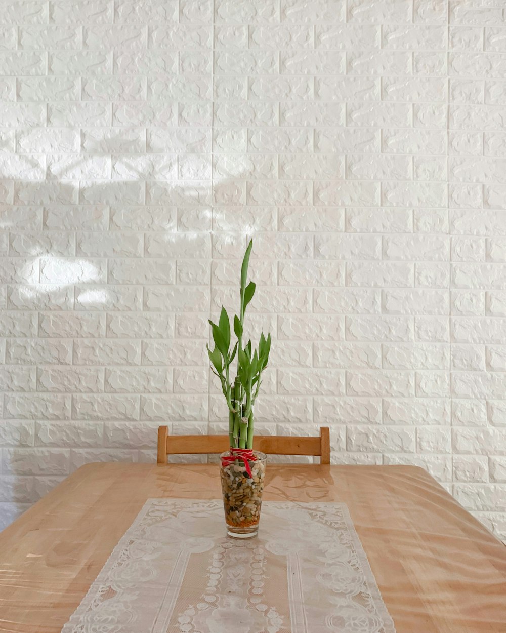 green plant in clear glass vase on brown wooden table