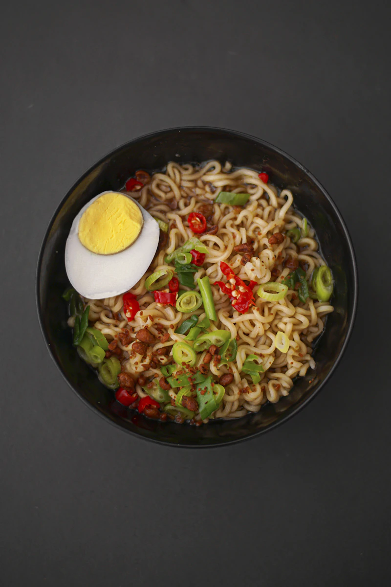 Noodles in a black ceramic bowl — placeholder