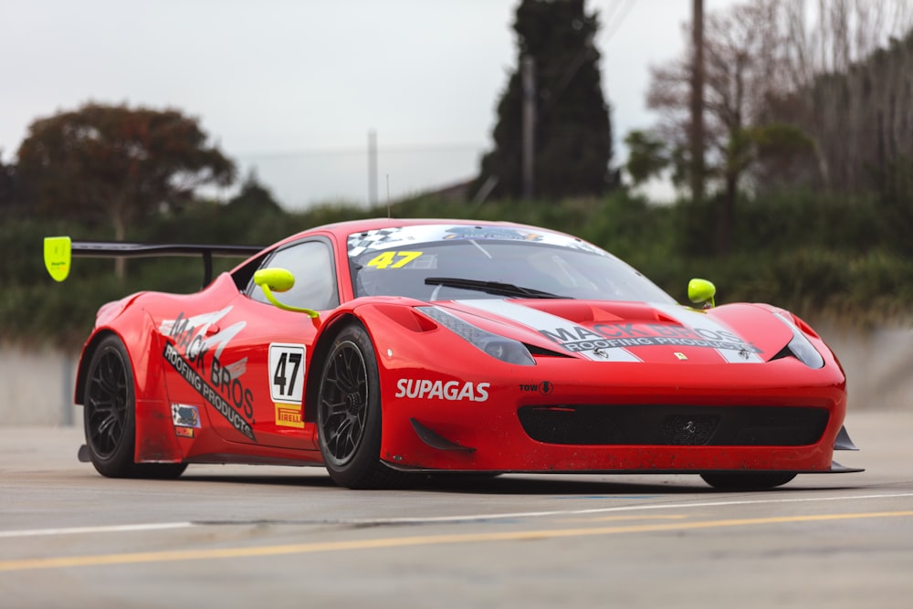 red ferrari f 1 on road during daytime