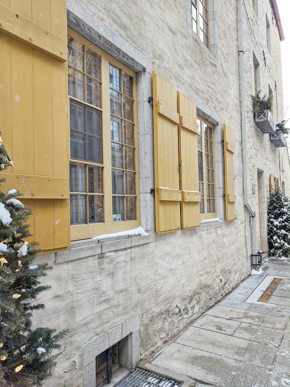 yellow wooden door on gray concrete wall