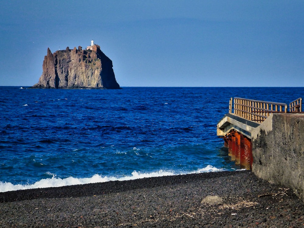 brown concrete building near sea during daytime