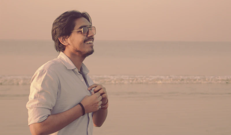 man in white polo shirt and black glasses