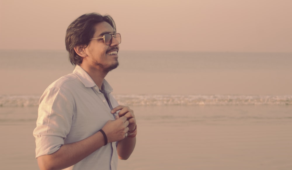 man in white polo shirt wearing black framed eyeglasses