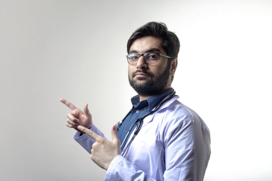 man in white dress shirt wearing black framed eyeglasses