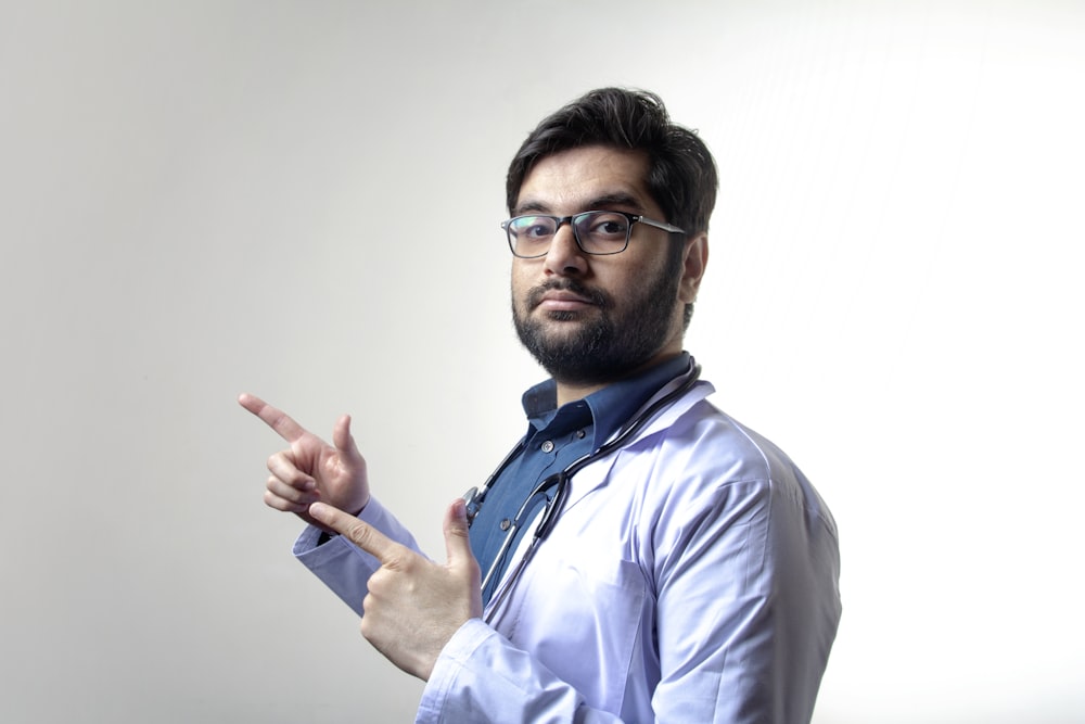 man in white dress shirt wearing black framed eyeglasses