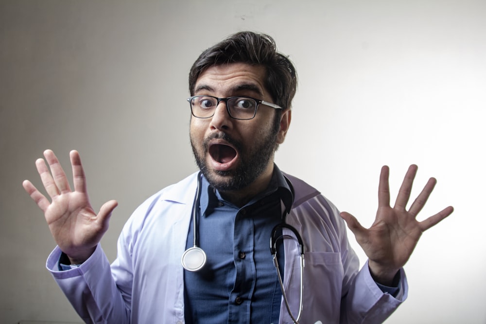 man in white dress shirt wearing black framed eyeglasses