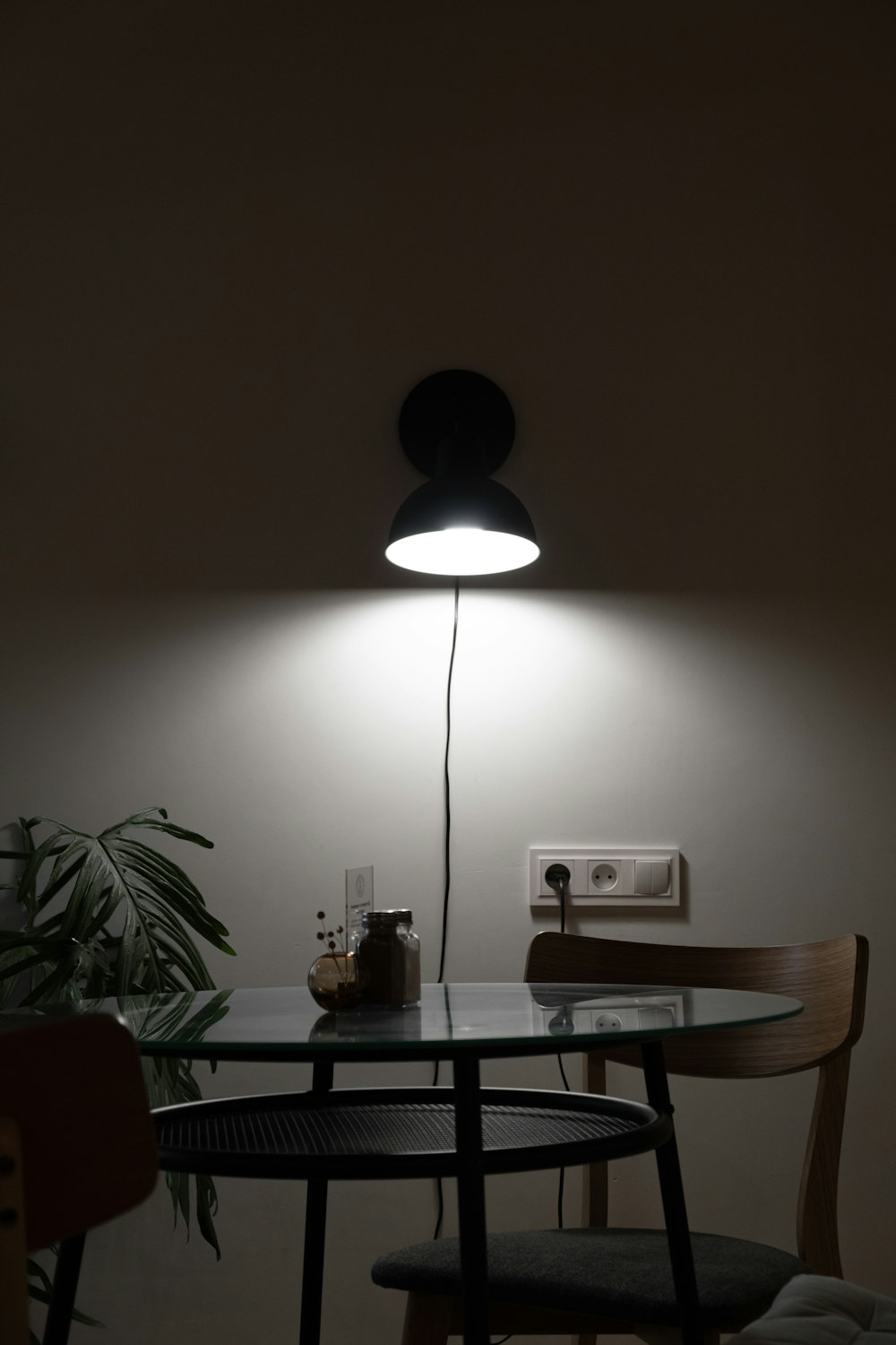 black pendant lamp turned on near brown wooden table
