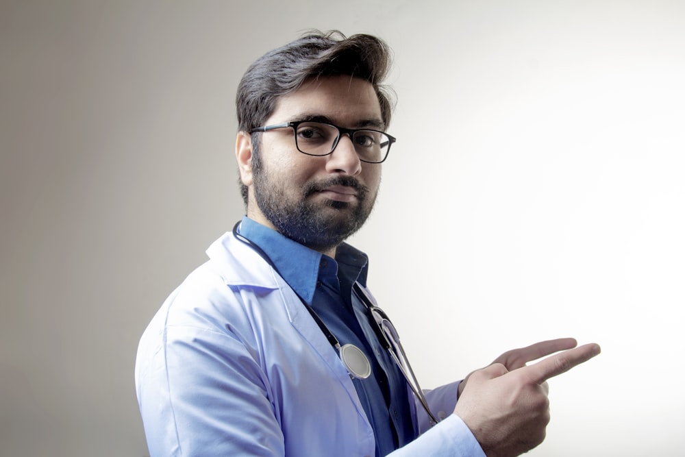 man in blue dress shirt wearing black framed eyeglasses