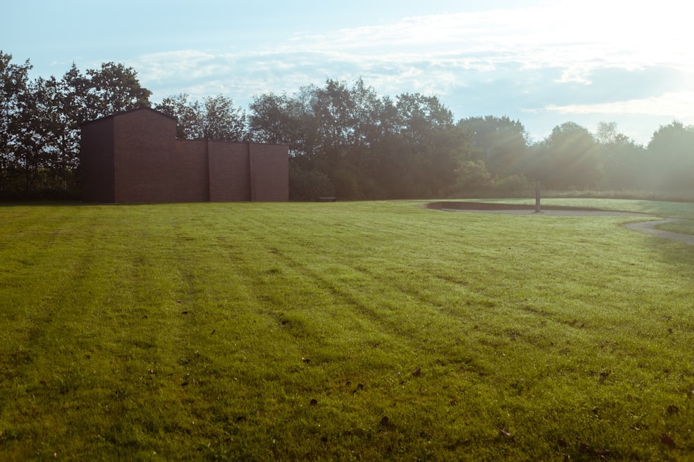 brown concrete building near green grass field during daytime