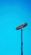 black microphone on blue background