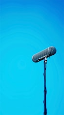black microphone on blue background