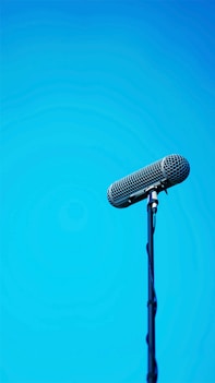 black microphone on blue background