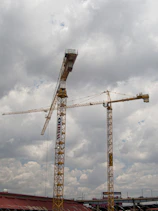 yellow crane under cloudy sky during daytime