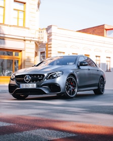 black mercedes benz coupe parked on street during daytime