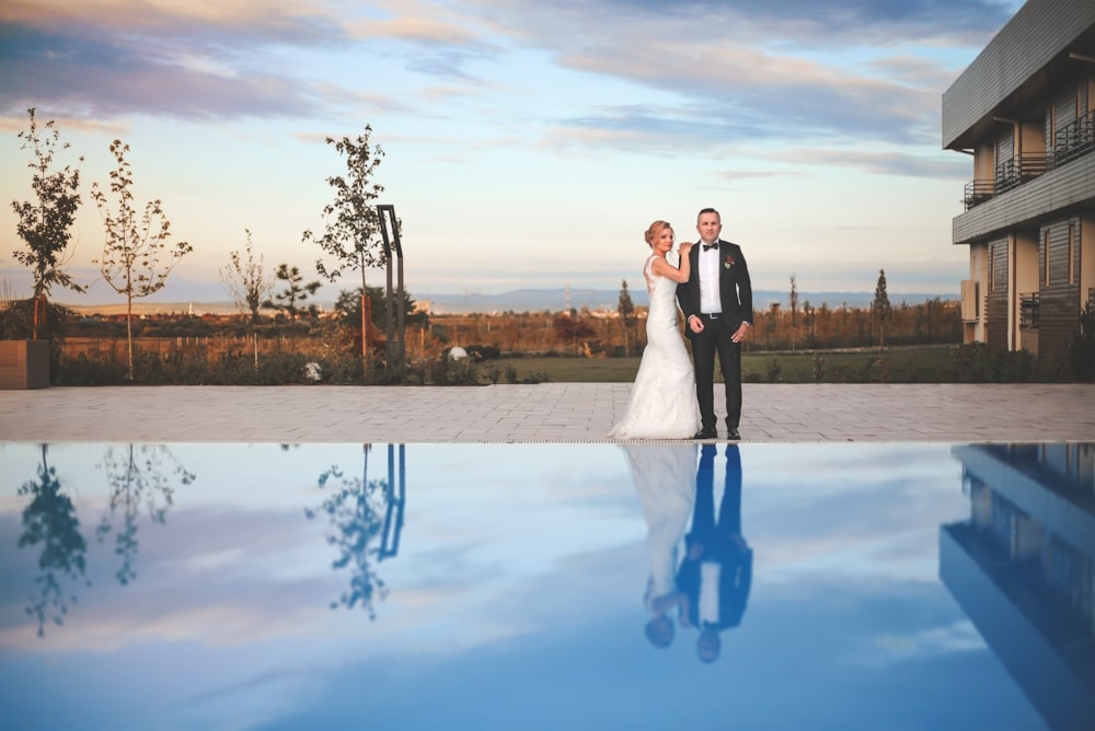 man and woman standing on snow covered ground during daytime