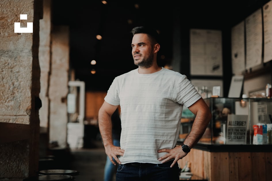 Man in white crew neck t-shirt and blue denim jeans standing near brown  wooden fence photo – Free Work life balance Image on Unsplash