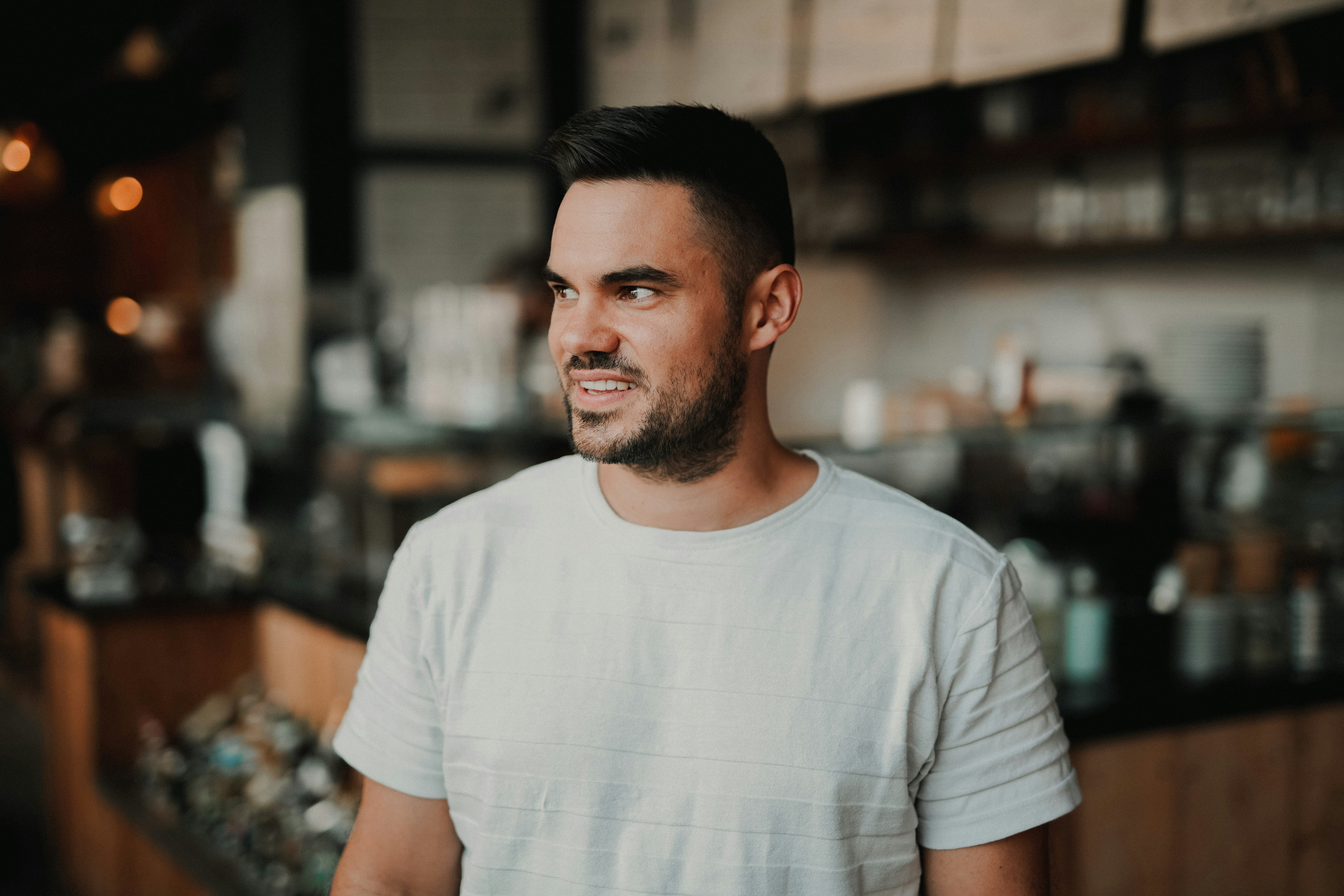 Malte Helmhold in a bar wearing casual cloth ready to have a drink.