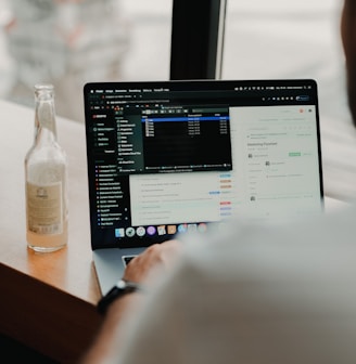 person using macbook pro on table