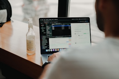 person using macbook pro on table