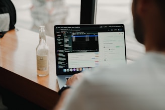 person using macbook pro on table