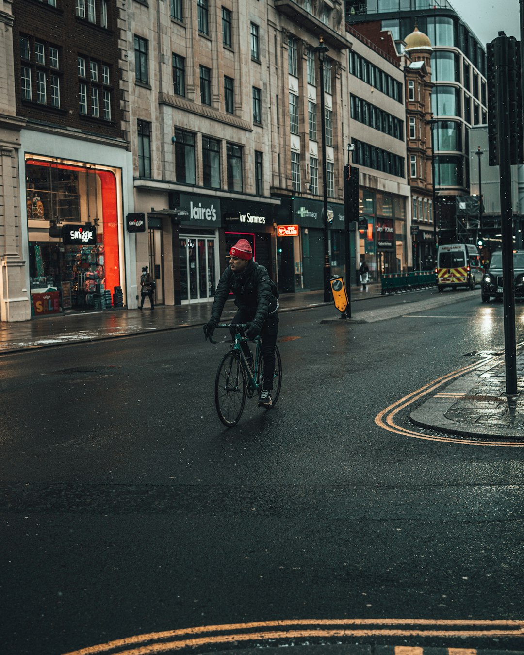 man in black jacket riding bicycle on road during daytime