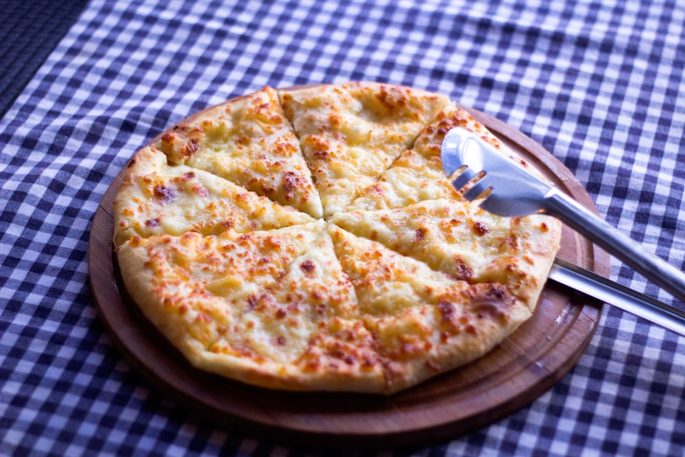 pizza on brown wooden tray