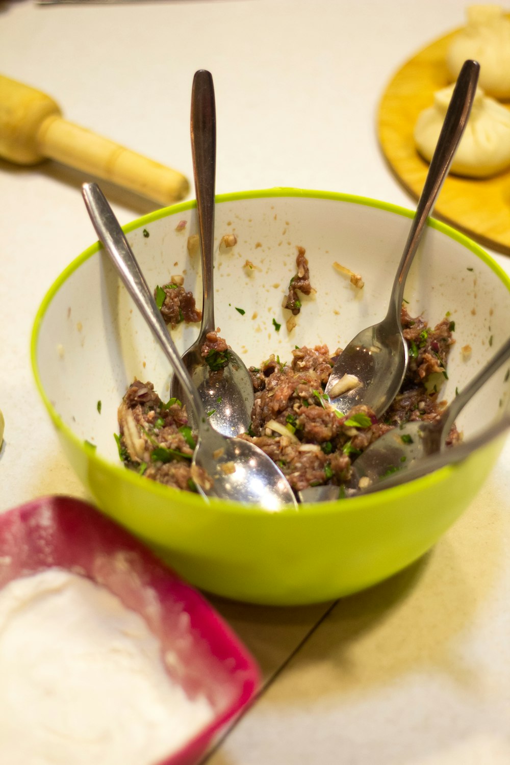 stainless steel spoon on green ceramic bowl