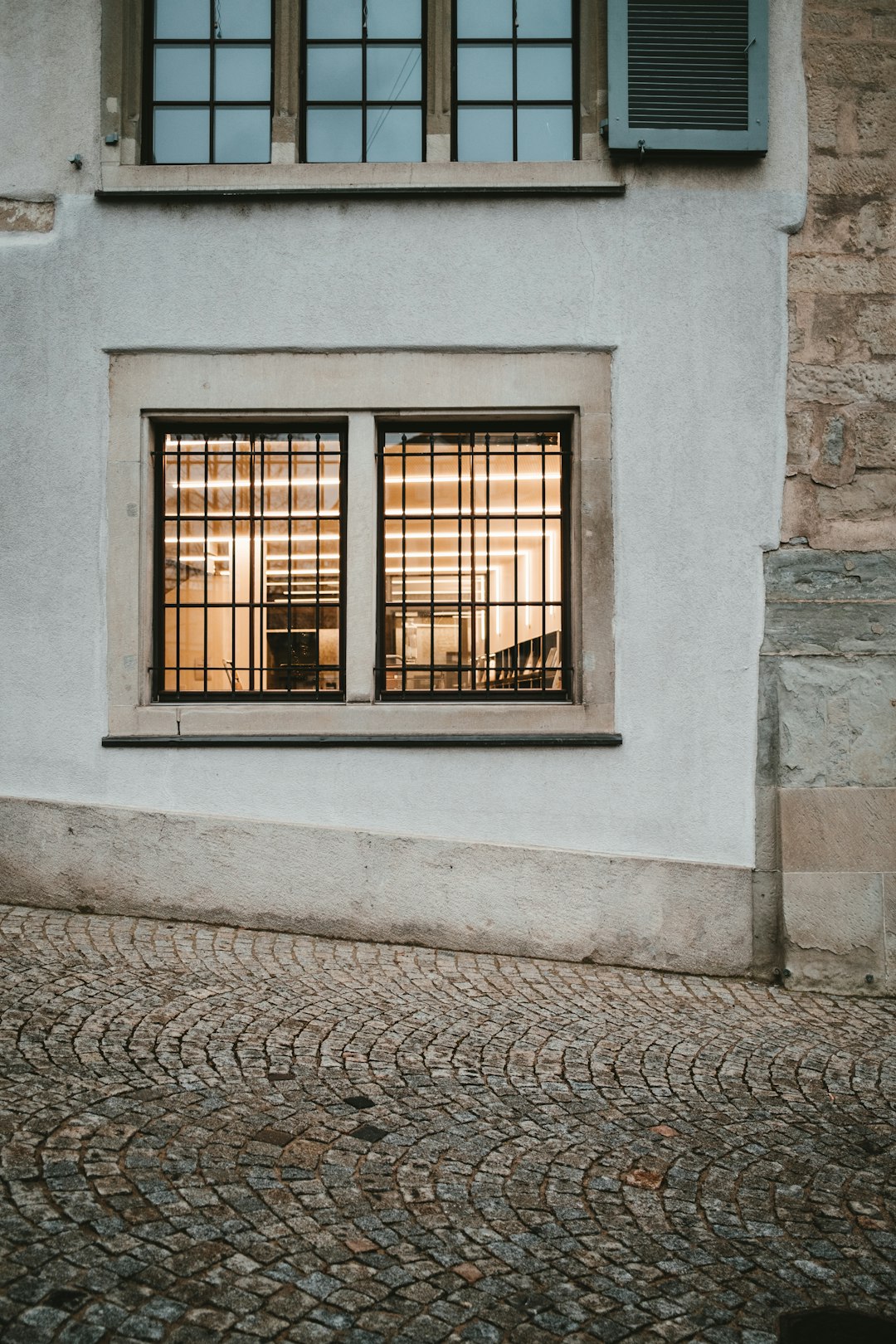 black metal window frame on white concrete wall