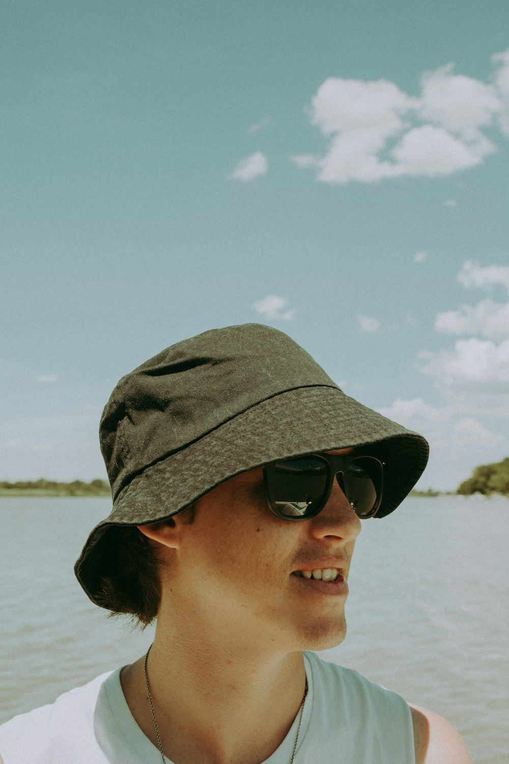 man in black sunglasses and green camouflage hat