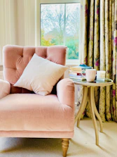 pink sofa chair with throw pillows