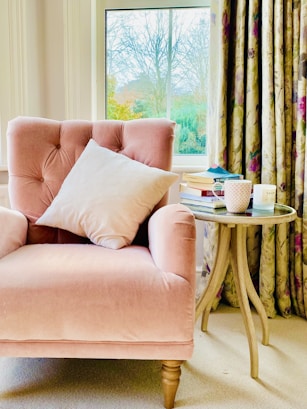 pink sofa chair with throw pillows