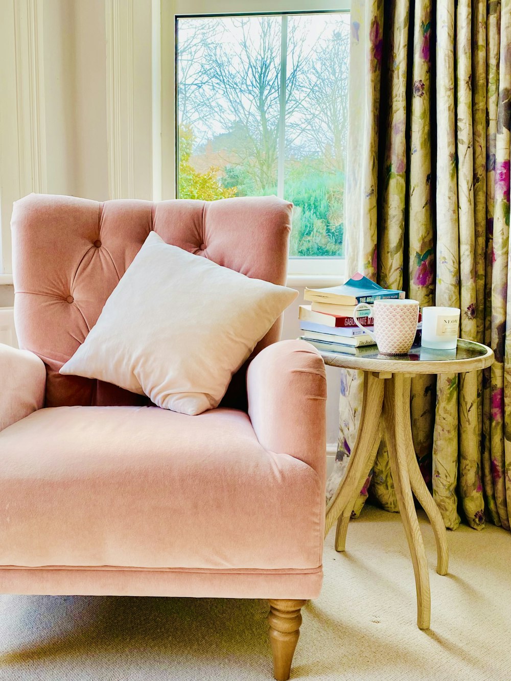 pink sofa chair with throw pillows