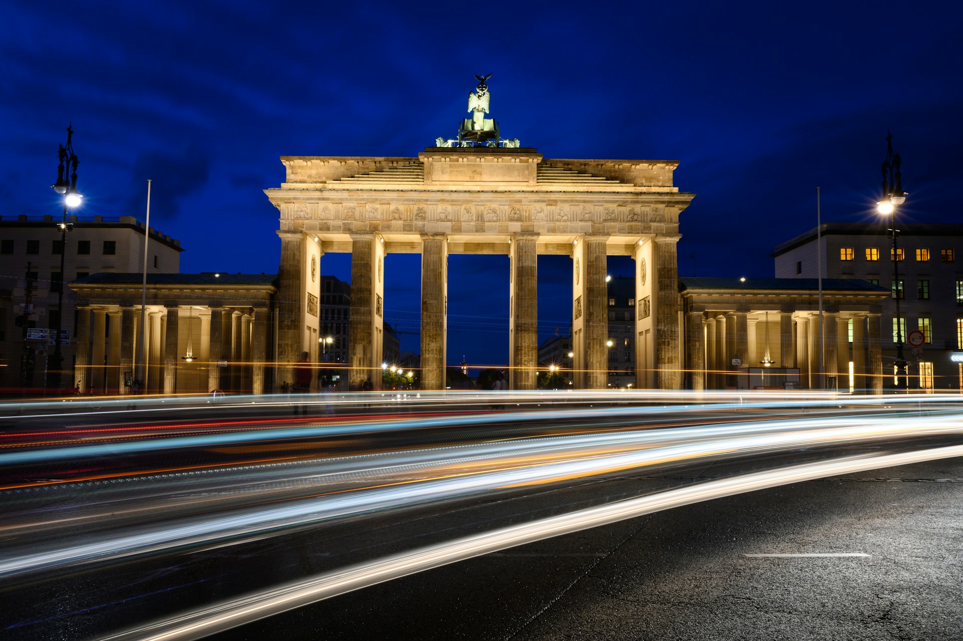 time lapse photography of cars on road near building during night time