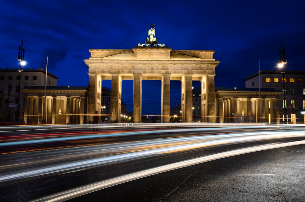 time lapse photography of cars on road near building during night time