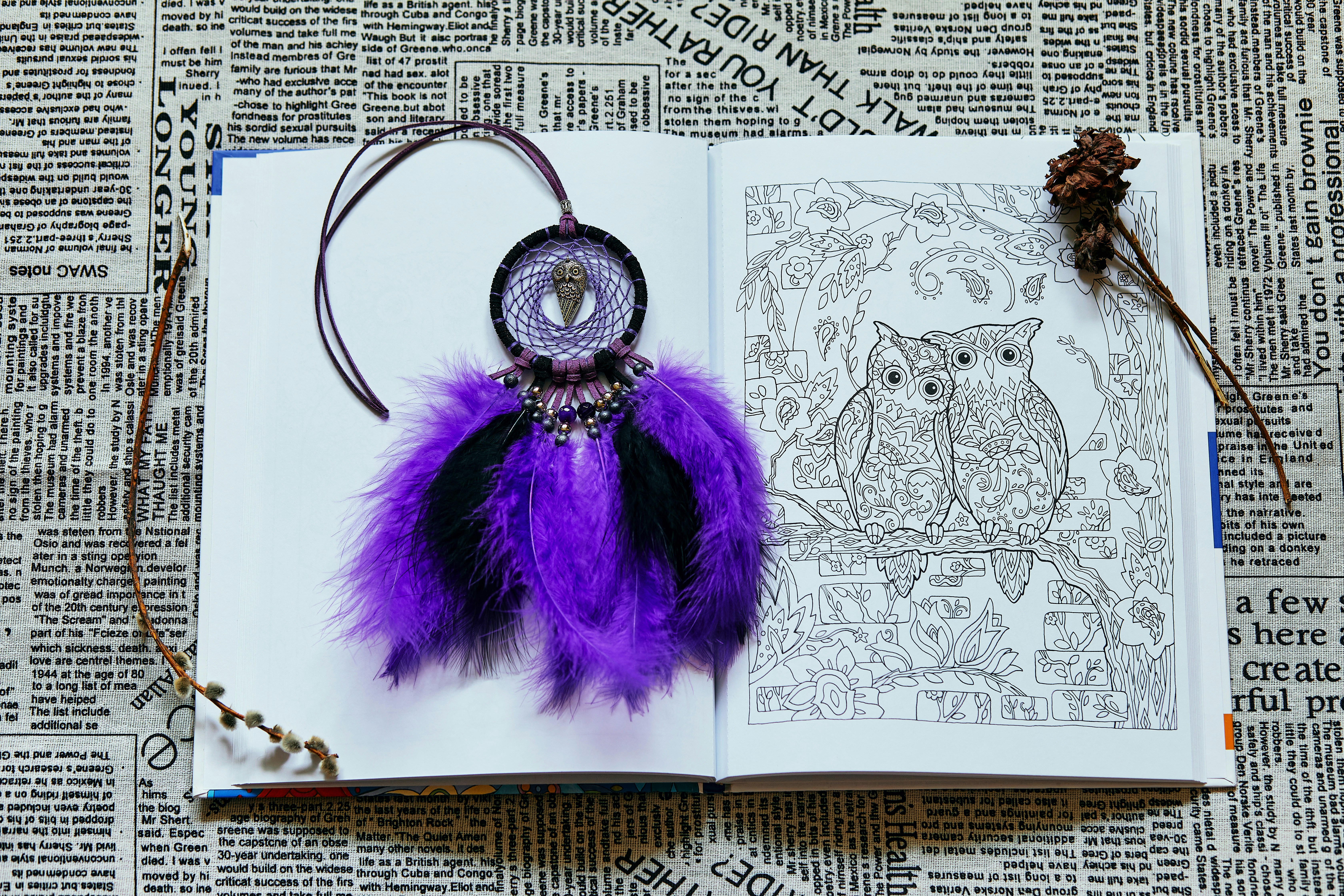 purple and silver keychain on white paper