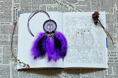 purple and silver keychain on white paper
