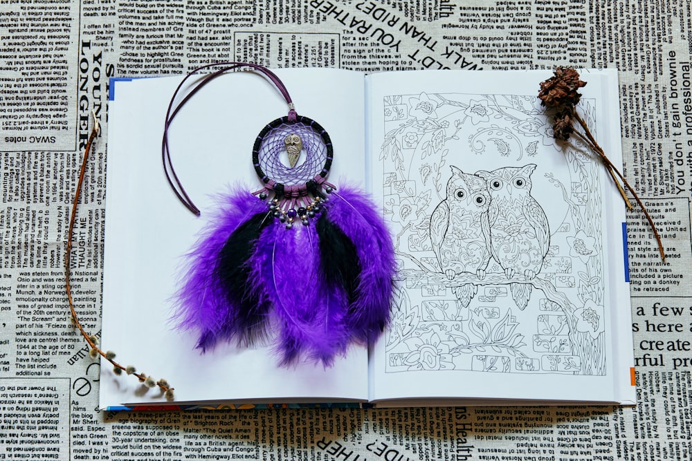 purple and silver keychain on white paper