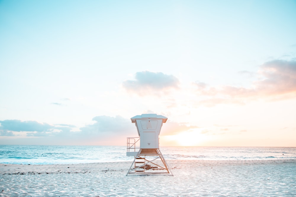 brown wooden lifeguard house on beach during daytime