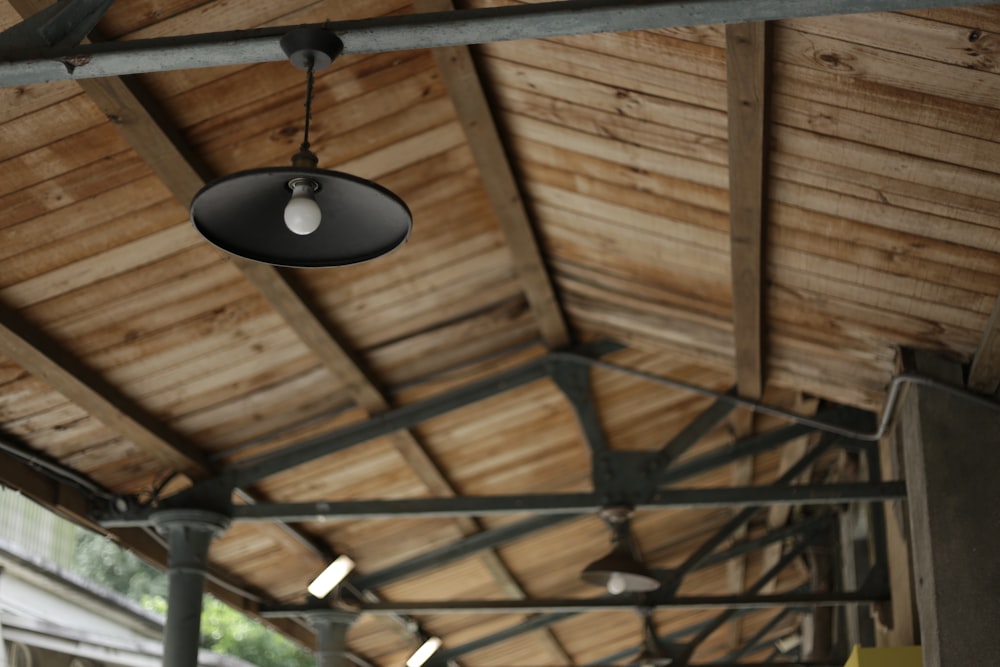 black pendant lamp turned on during daytime