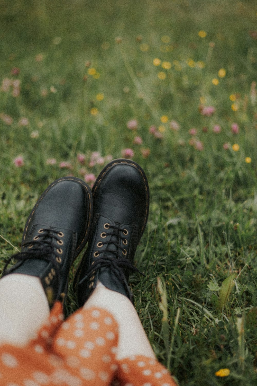 person wearing black leather shoes