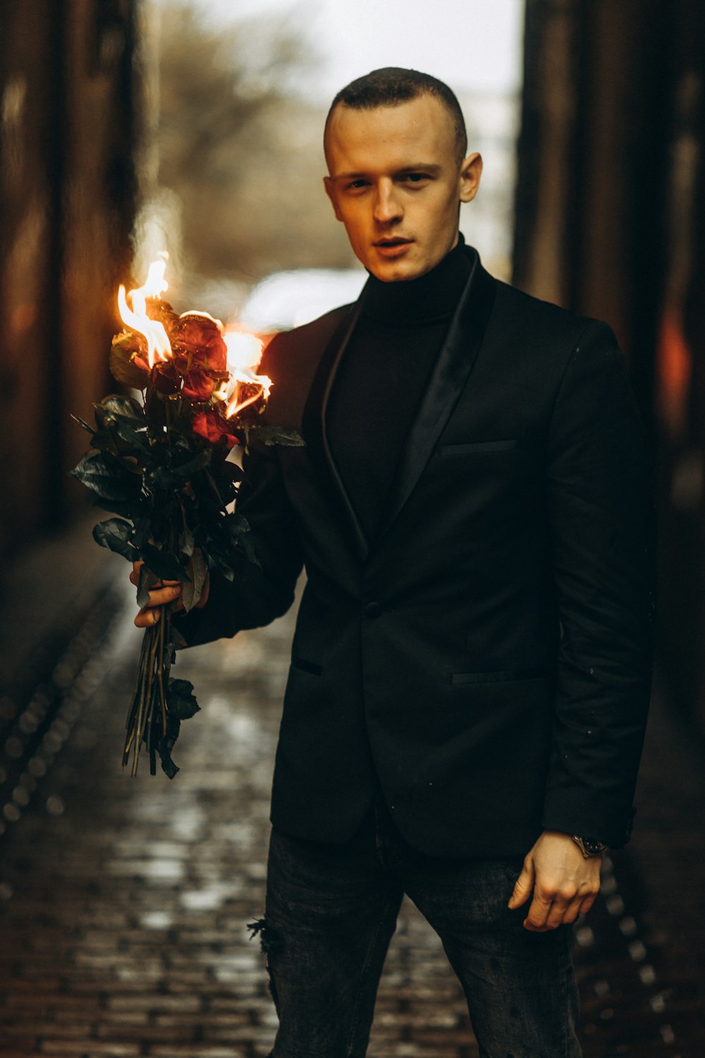 man in black suit holding fire