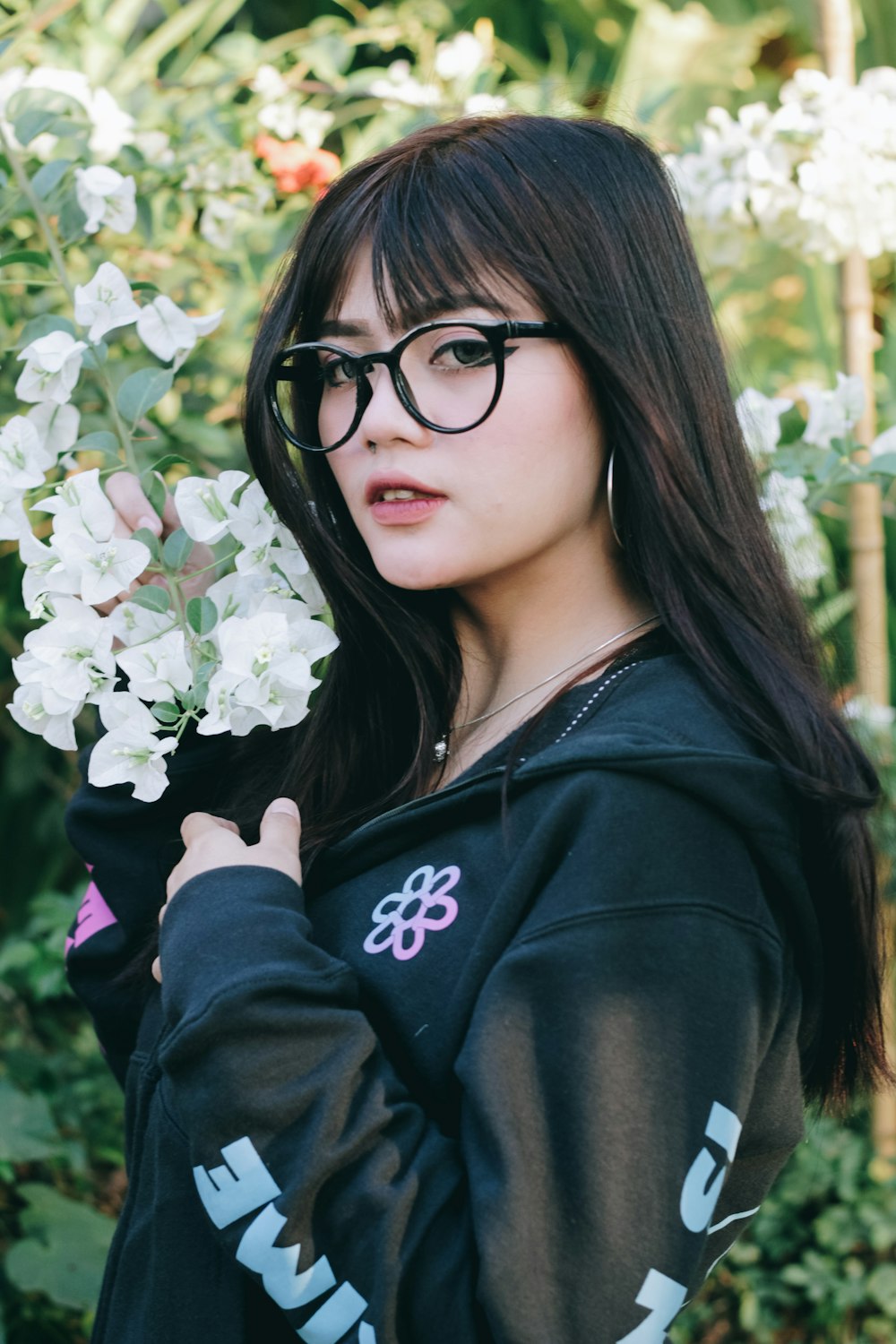 woman in black hoodie wearing black framed eyeglasses