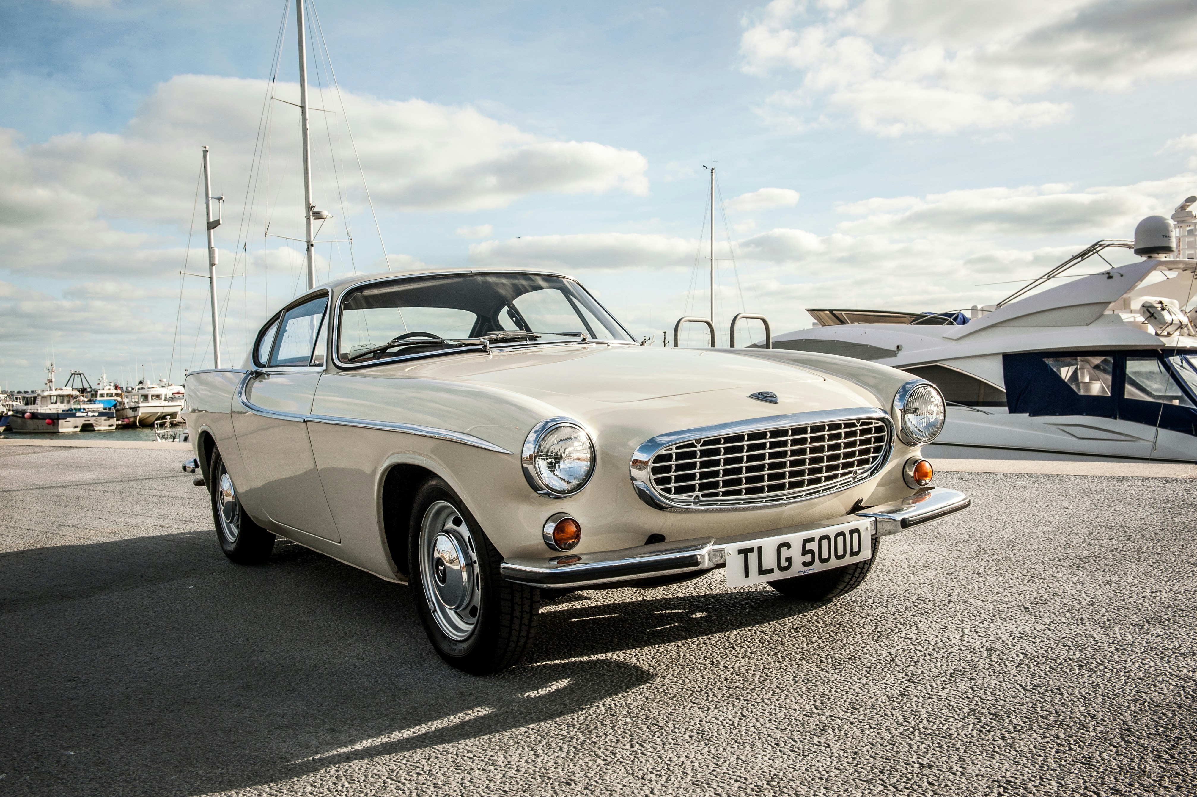 silver mercedes benz coupe on gray asphalt road during daytime