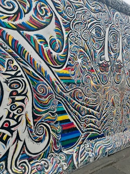 A vibrant mural showcasing African tribal art with bold colors and intricate patterns.