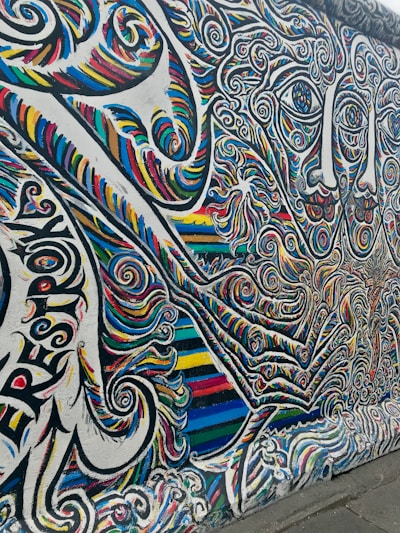A vibrant mural painted by a neurodiverse artist, bursting with colors and intricate patterns.