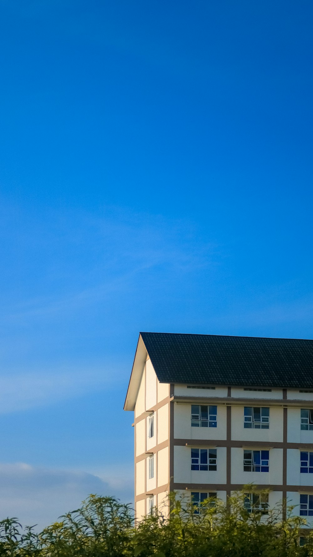 white and black wooden house under blue sky during daytime